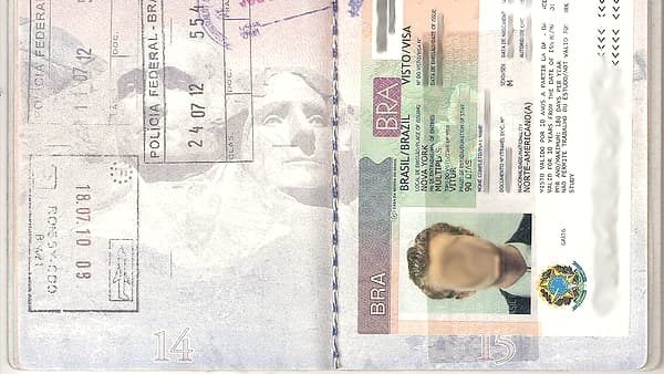 A page of visa and border stamps inked across the pages of a travel document