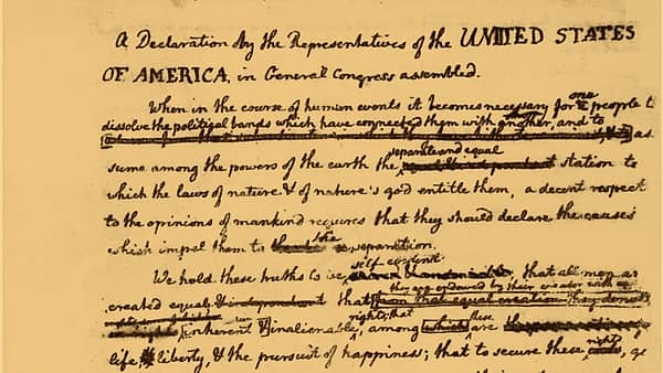 A detail of a heavily corrected handwritten draft with words struck through and inserted between the lines