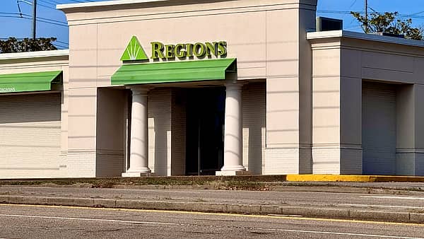 The exterior of a suburban bank branch photographed from the parking lot in daylight