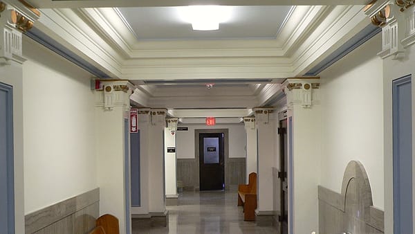 The interior corridor of a county courthouse with doors along one side