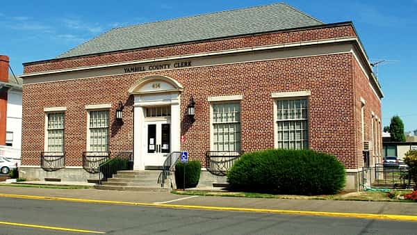 The exterior of a county clerk's office building on a small-town street