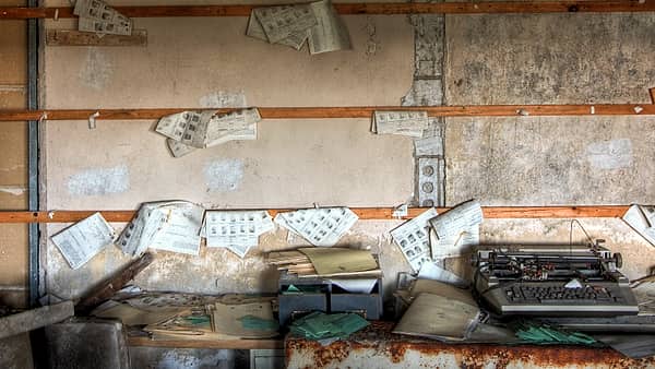 A records room lined with shelves of employee files in labelled folders