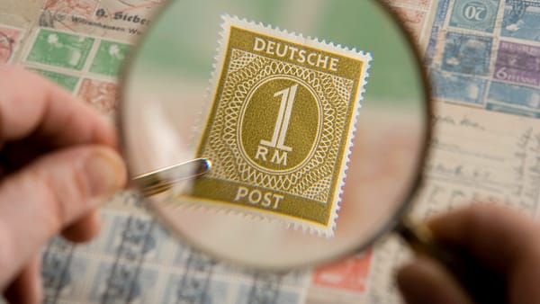 A magnifying glass held over printed material, enlarging the detail beneath it