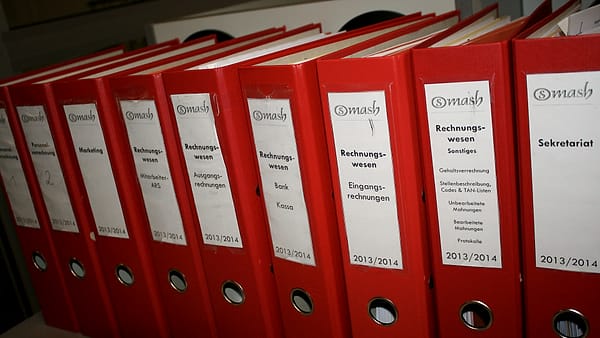 A row of colored document folders standing upright in a filing tray
