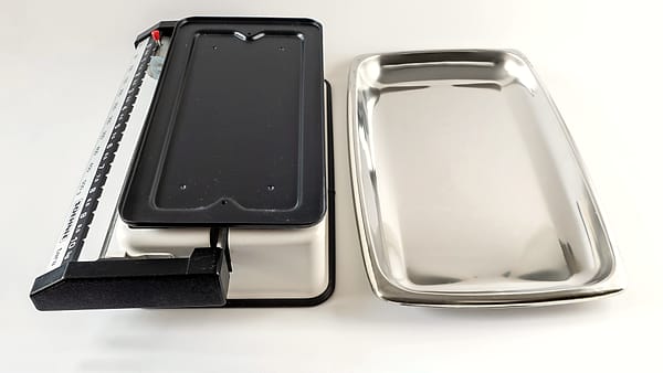 A kitchen weighing scale with a detachable tray, photographed on a work surface