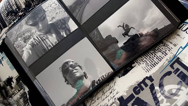 An open photograph album showing pages of mounted family pictures