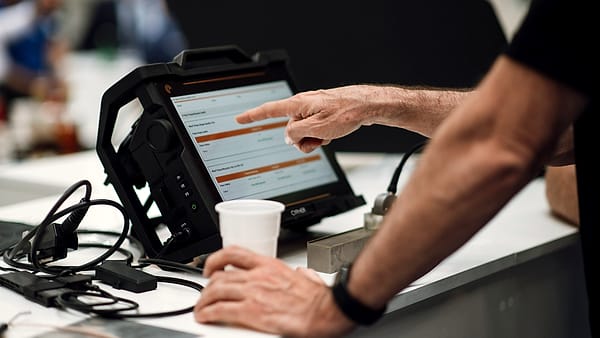 A person holding a tablet computer and interacting with the screen