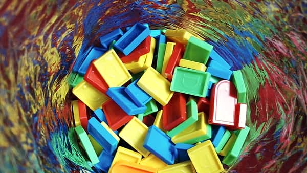 Colored dominoes laid out in lines across a plain playing surface