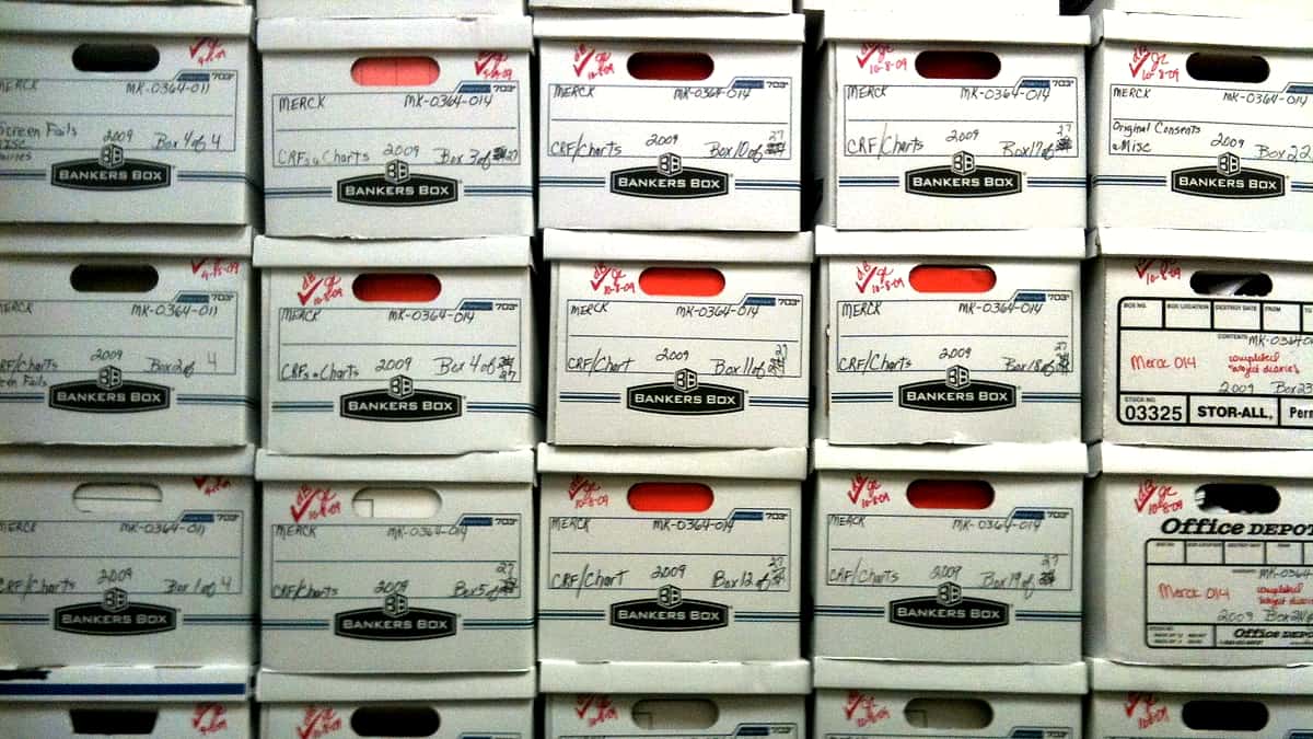 Stacks of cardboard archive boxes packed together on shelving
