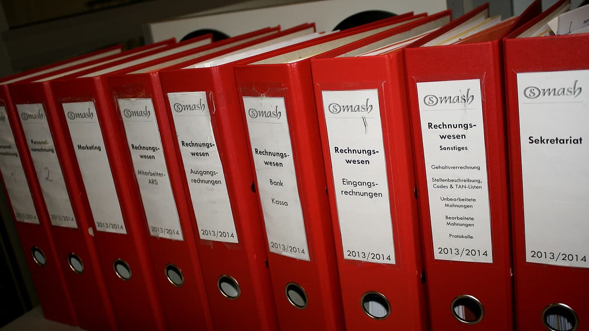 A row of colored document folders standing upright in a filing tray