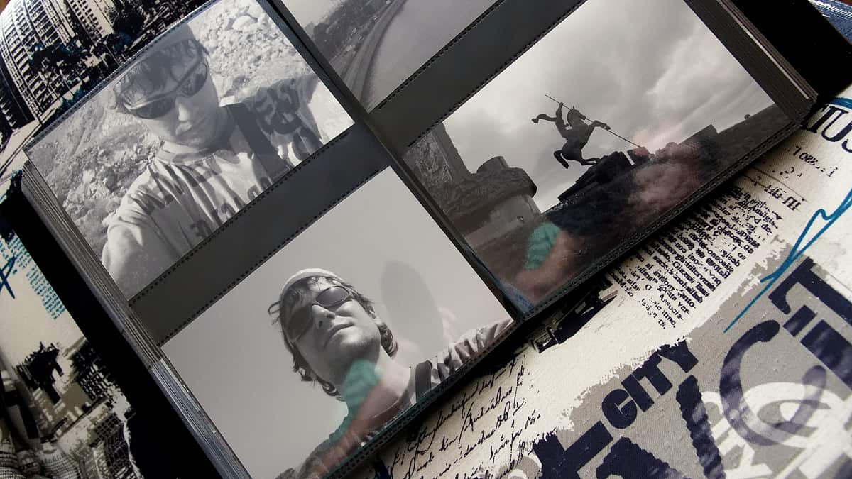 An open photograph album showing pages of mounted family pictures