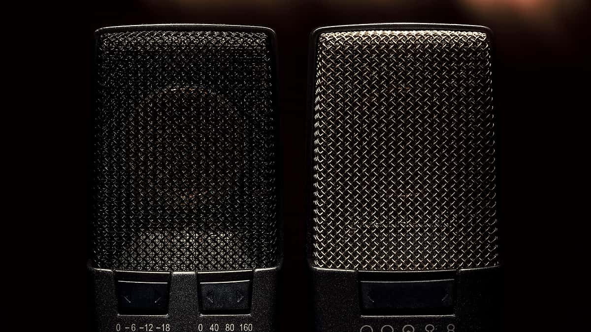 A close view of a condenser microphone showing its grille and pattern selector